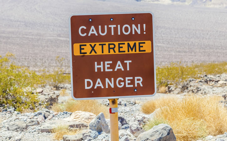 Sign in desert reads "Caution! Extreme Heat Danger"