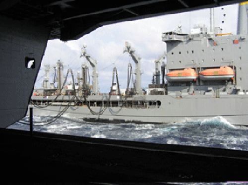 July 21, 2006 – View from the hangar bay of the USS Eisenhower, Military Sealift Command oiler USNS John Lenthall (T-AO 189) alongside the Eisenhower during an underway refueling.