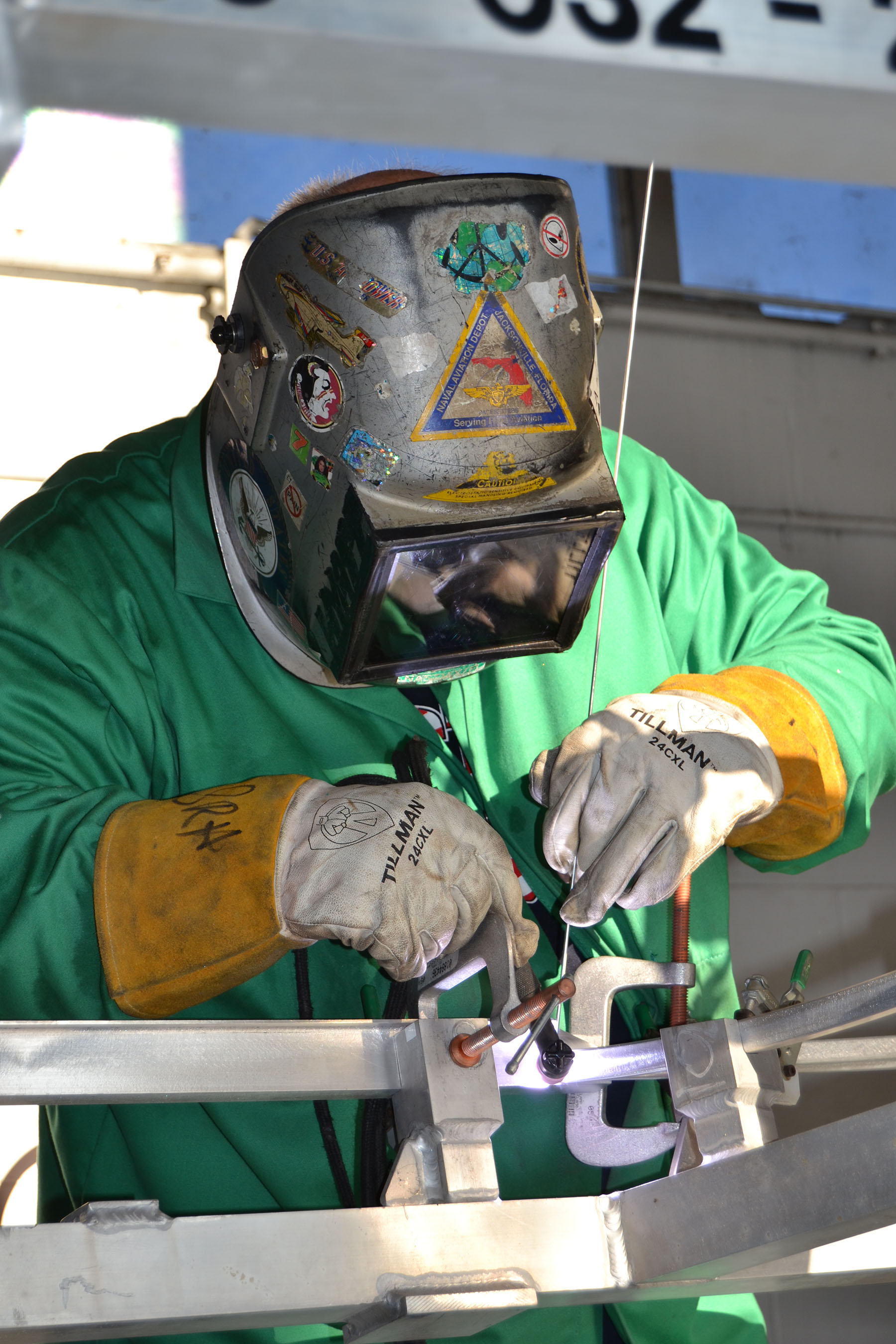 Steve Hyatt, a welder at Fleet Readiness Center Southeast (FRCSE), welds joints together on a Bell AH-1Z Viper helicopter canopy door frame in the FRCSE welding shop July 10. Photo courtesy of U.S. Navy.