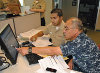 FORT WORTH, Texas (June 12, 2010) Chief Hospital Corpsman Hugo A. Castellanos, right, a Reserve Component member assigned to Operational Health Support Unit, Dallas, Detachment F, works with Personnel Specialist 3rd Class Mukarram Hossain, manpower clerk at Navy Operational Support Center Fort Worth, as they review Castellano's Electronic Service Record.