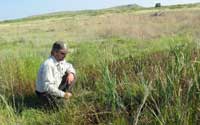 Photo of Jude Smith observing restored spring on Muleshoe NWR