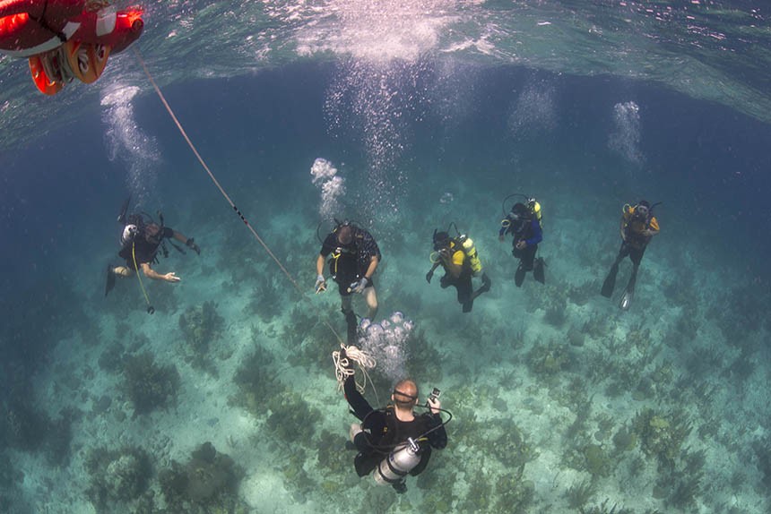 Navy Diver 2nd Class Zoe Young, assigned to Mobile Diving and Salvage Unit Two (MDSU 2), Company 2-1, descends on a buoy line to begin a joint training dive with Belize Coast Guard divers off the coast of Belize. U.S. Navy photo by Mass Communication Specialist 1st Class Brett Cote.