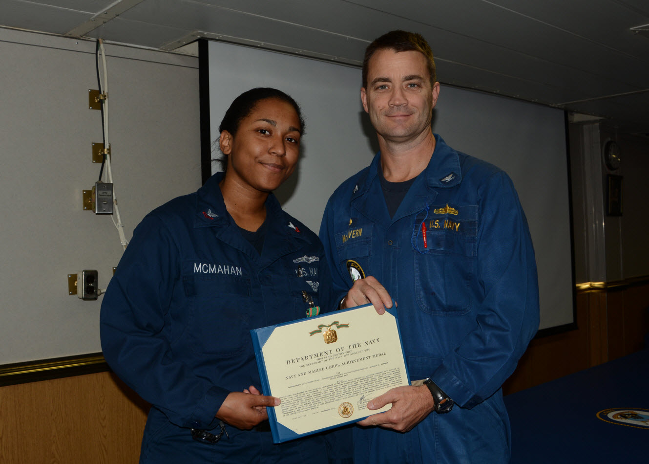 Aerographer’s Mate Second Class (IDW/AW) Lachelle M. McMahan receives an “On-The-Spot” Navy and Marine Corps Medal from the Commanding Officer of the USS Iwo Jima (LHD 7), Capt. J. E. McGovern for her part in the rescue of a missing Sailor. McMahan and AG1(IDW) Tara M. Crow used their skills to assist the USS New York (LPD 21) locate a missing Sailor during an Amphibious Readiness Group exercise off the coast of South Carolina on Sept. 11.  U.S. Navy Photo by Chief Mass Communication Specialist Lori A. Steenstra.