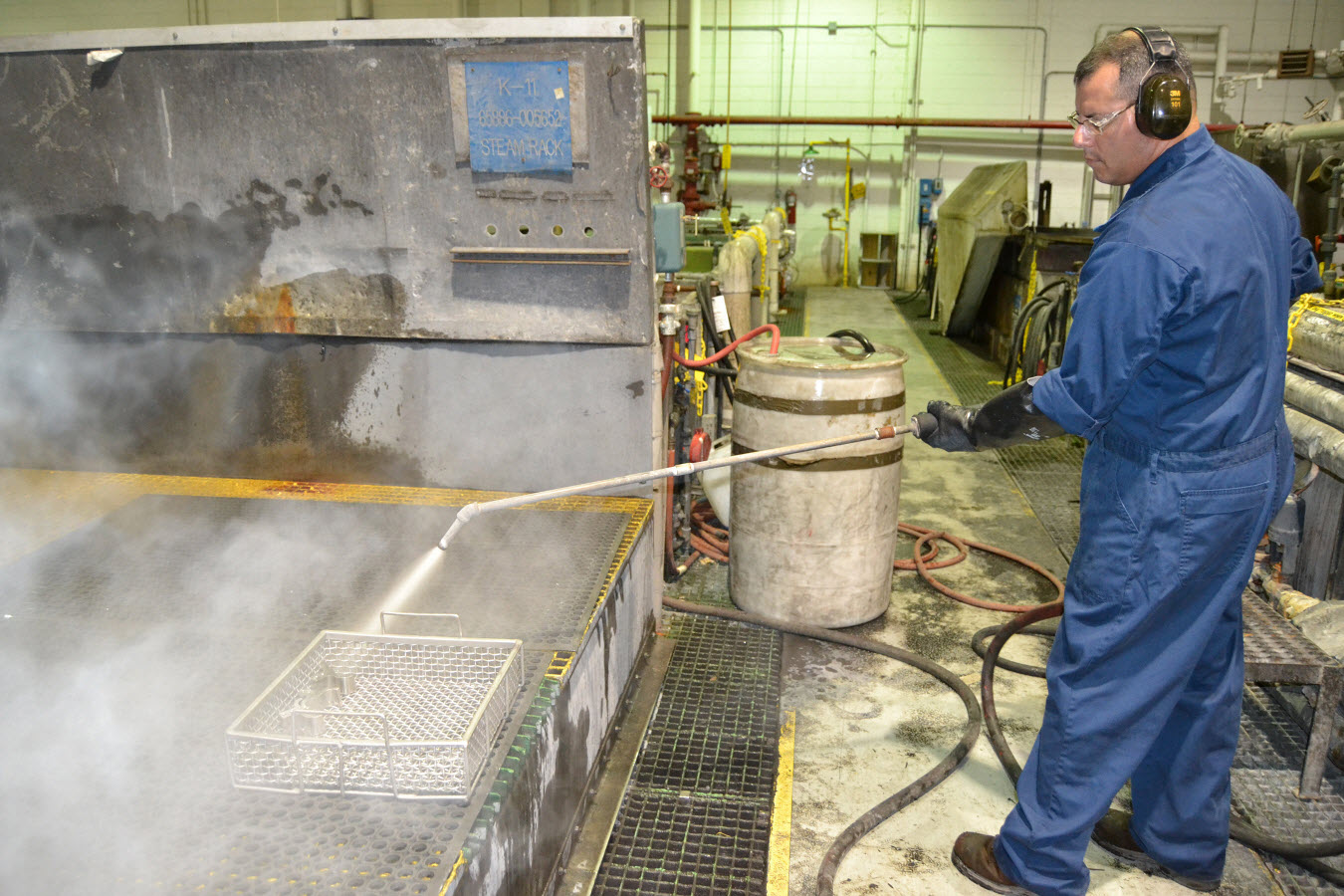 Raymond Gomez, an equipment cleaner at Fleet Readiness Center Southeast (FRCSE), steam cleans a batch of F/A-18E/F Super Hornet 20mm gun insert blast diffusers to remove grease residue from the parts in the FRCSE Engine Clean and Finish Shop Sept. 10. U.S. Navy photo.