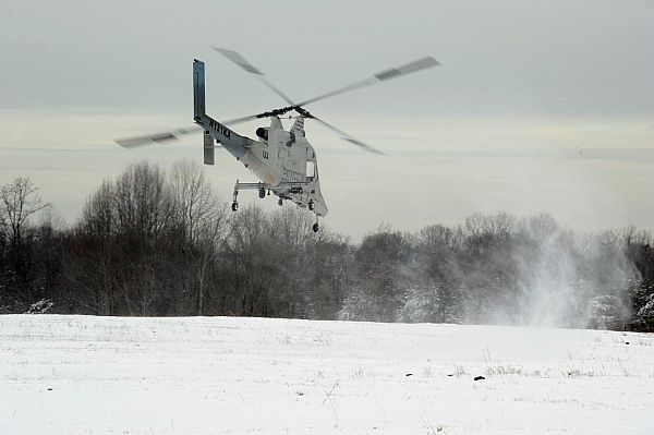  QUANTICO, Va. (Mar. 18, 2014) A Kaman K-Max helicopter equipped with the Autonomous Aerial Cargo/Utility System (AACUS) technology lifts off during an Office of Naval Research (ONR) demonstration held at the Marine Corps Base Quantico, Va. AACUS consists of a sensor and software package that when integrated into rotary wing aircraft enables autonomous, unmanned flight, allowing the Marine Corps to rapidly resupply forces on the front lines as an alternative to dangerous convoys, manned aircraft or air drops in all weather conditions. (U.S. Navy photo by John F. Williams)