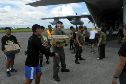 GUIUAN, Eastern Samar Province, Republic of the Philippines (Nov. 17, 2013) Philippine citizens gather around an MH-60S Sea Hawk helicopter from the Golden Falcons of Helicopter Sea Combat Squadron (HSC) 12 as it delivers relief supplies in support of Operation Damayan. The George Washington Carrier Strike Group supports the 3d Marine Expeditionary Brigade to assist the Philippine government in response to the aftermath of Super Typhoon Haiyan in the Republic of the Philippines. U.S. Navy photo by Mass Communication Specialist 3rd Class Peter Burghart. 