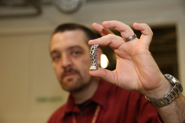 James Zunino, Picatinny Materials Engineer, displays an object that was created by an additive printing process. 3D printing gives engineers the flexibility to quickly print items of various shapes, materials and structure. Photo by Erin Usawicz.