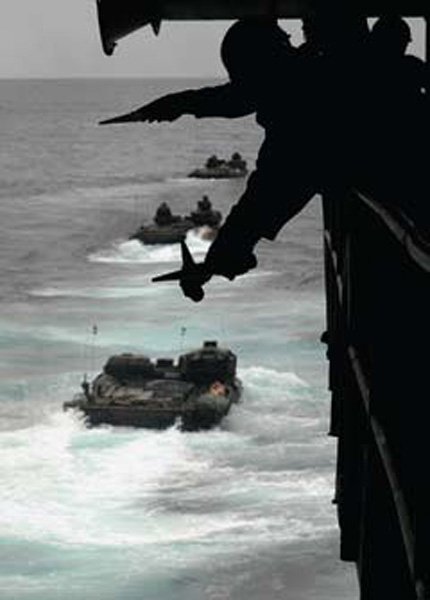 PACIFIC OCEAN (Feb. 18, 2008) Seaman Keanne Q. Douglas crosses his wands to signal a Marine amphibious assault vehicle to hold position during a launch from the well deck of the amphibious transport dock USS Juneau (LPD 10). U.S. Navy photo by Mass Communication Specialist 1st Class Michael D. Kennedy.