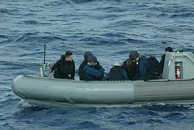 A team aboard the RHIB transfers files to USS Carney during recent tests for a wireless link in support of maritime intercept operations.