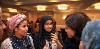 Three women talking at a table. (D.A. Peterson/Dept. of State)