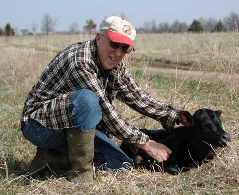 Fred Martz alongside one of his cows.