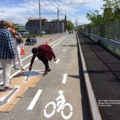 College students install a protected bikeway demonstration project in Lewiston, Maine (Credit: Street Plans)