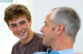 	causasian teen talking to father