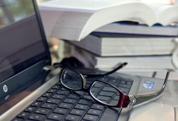 	Computer and glassess signifying person at work