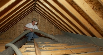 Cellulose, a fiber insulation material with a high recycled content, is blown into a home attic. | Photo courtesy of Cellulose Insulation Manufacturers Association.