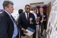 A student explains an EM-supported applied research project to Mark Gilbertson, EM Deputy Assistant Secretary for Site Restoration, left, at a Historically Black Colleges and Universities workshop held at Savannah River National Laboratory in April 2014.