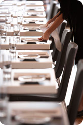 Restaurant server setting tables