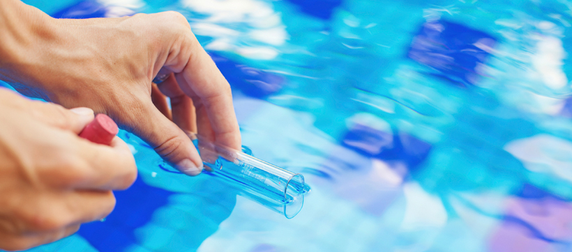 testing the water with a pool chemical kit