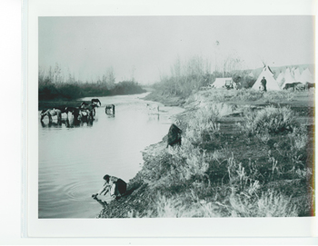 Archival image of Crow women getting water from river