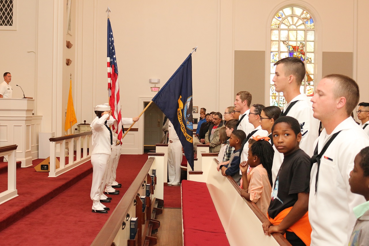 PENSACOLA, Fla. (Nov. 19, 2016) Saturday scholars and their mentors from Information Warfare Training Command Corry Station stand during the presentation of the colors at a graduation ceremony held at the Naval Air Station Pensacola chapel. The mentors were Navy "A" and "C" school students who teamed up with the New Warrington Elementary School students to complete the Saturday Scholars program, exploring science, technology, engineering and math (STEM) concepts.  IWTC Corry Station partnered with the Escambia County school district, continuing a 33-year-old tradition. Saturday Scholars is an example of the Navy's Personal Excellence Partnership Program, which strives for excellence in developing the youth of surrounding communities by promoting academic achievement, healthy lifestyles, and civic responsibility. U.S. Navy photo by Petty Officer 1st Class Brandon Greene/Released   