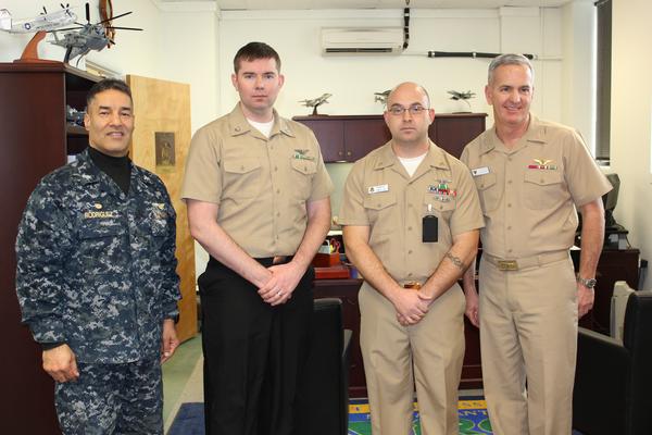 Capt. Joe Rodriguez (left), commander, Fleet Readiness Center Mid-Atlantic (FRCMA) congratulates Petty Officer Richard Walsh (second from left) and Senior Chief Ryan Balzer (second from right) on their receiving Secretary of the Navy (SECNAV) 2015 Innovation Awards. Also on hand to extend his congratulations was Capt. Keith Nixon (right), FRCMA executive officer.  U.S. Navy photo 