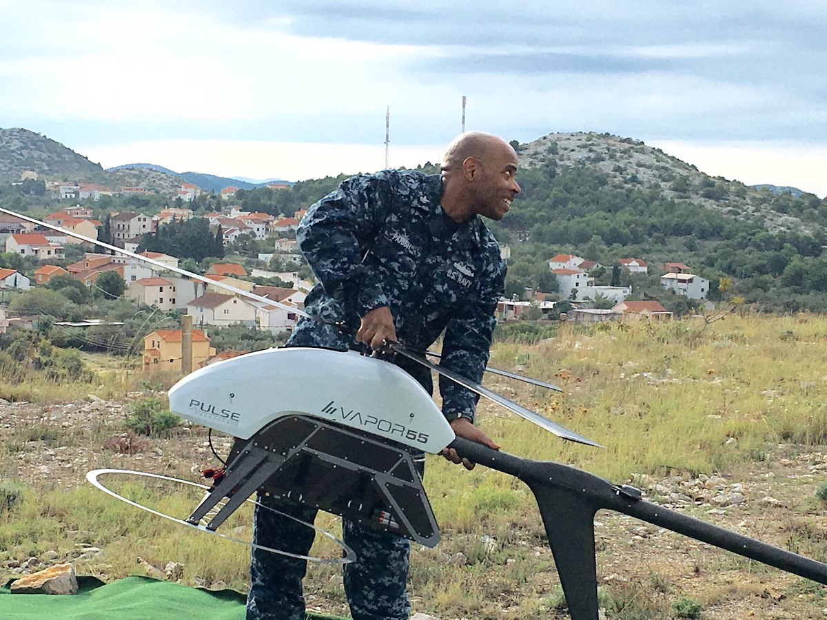 Biograd, Croatia. IT1 Vincent Parish placing the just assembled Vapor 55 UAV on the launch area.  The testing and evaluation for the Vapor has the goal of it working in the future autonomously from a ship.
 
