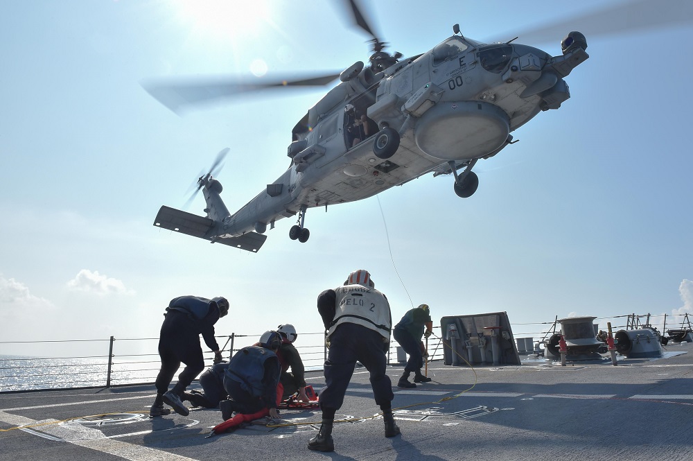 SOUTH CHINA SEA (Oct. 28, 2015) U.S. Navy Sailors participate in a medical training exercise on the forecastle of the Arleigh Burke-class guided missile destroyer USS Lassen (DDG 82) with an MH-60R Sea Hawk helicopter assigned to the "Warlords" of Helicopter Maritime Strike Squadron 51. Lassen is on patrol in the 7th Fleet area of operation in support of security and stability in the Indo-Asia-Pacific region. U.S. Navy photo by Mass Communication Specialist 2nd Class Corey T. Jones 