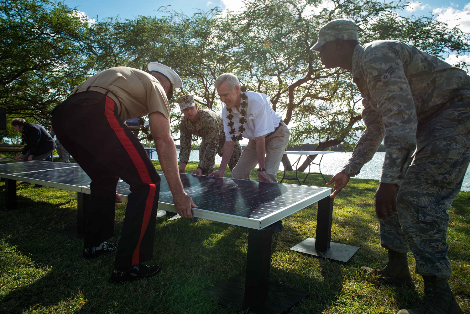 PEARL HARBOR (July 24, 2014) Secretary of the Navy (SECNAV) Ray Mabus, center, helps place a ceremonial solar panel during a ground breaking and blessing ceremony at the USS Nevada Memorial at Hospital Point. The ceremony signifies the start of the Navy's largest solar power generation system project in Hawaii. Mabus is in the region to meet with Sailors and Marines, and civilian and military officials, as part of a multi-nation visit to the U.S. Pacific and Africa Command areas of responsibility. U.S. Navy photo by Mass Communication Specialist 2nd Class Armando Gonzales 