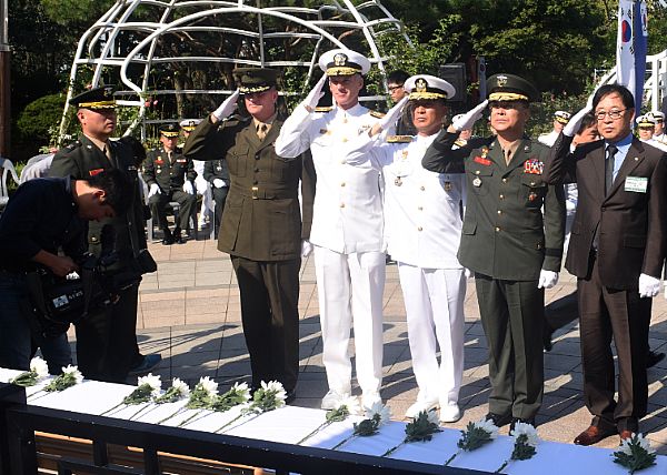 INCHEON (Sept. 15, 2015) Rear Adm. William Byrne, center, commander of U.S. Naval Forces Korea, renders a salute along with Republic of Korea senior military service members at the Gen. Douglas MacArthur memorial statue in Incheon, during the 65th Annual Incheon Amphibious Landing Operations Commemoration Ceremony. U.S. Navy photo by Mass Communication Specialist 1st Class Abraham Essenmacher.