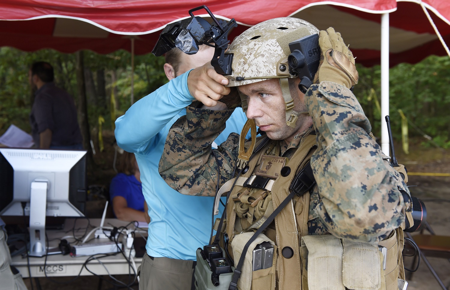 A Marine is fitted with the Augmented Immersive Team Trainer (AITT) from the Office of Naval Research (ONR) during on-going testing at Quantico, Va. The AITT allows Marines to transform any location into a dynamic training ground by injecting virtual images, indirect fire effects, aircraft, vehicles, simulated people, etc. onto a real-world view of one's surroundings. U.S. Navy photo by John F. Williams 