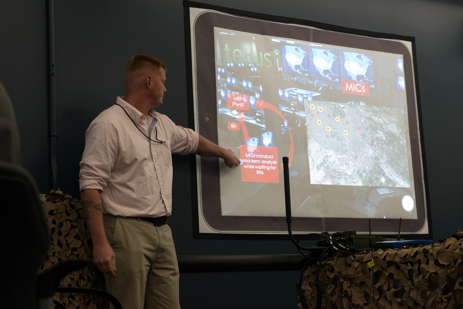 Staff Sgt. Joel Crenshaw, a cohort with the Accelerator team presents the new Tellus program to Brig. Gen. Michael Groen, the director of Marine Corps Intelligence during a presentation hosted by Mantech Spaces in Stafford, Va., May 29, 2015. 