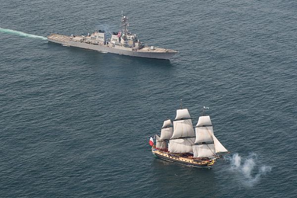 ATLANTIC OCEAN (June 2, 2015) The Arleigh Burke-class guided-missile destroyer USS Mitscher (DDG 57), right, provides a warm welcome to the French tall ship replica the Hermione in the vicinity of the Battle of Virginia Capes off the East Coast of the United States. The original Hermione brought French Gen. Marquis de Lafayette to America in 1780 to inform Continental Army Gen. George Washington that a French army was headed for America to assist in the war effort. The symbolic return of the Hermione will pay homage to Lafayette and the Franco-American alliance that brought victory at the Battle of Yorktown in 1781. The Hermione will visit Yorktown, Va. June 5 and then continue up the East Coast visiting cities of Franco-American historical significance. U.S. Navy photo by Mass Communication Specialist 1st Class Michael Sandberg.