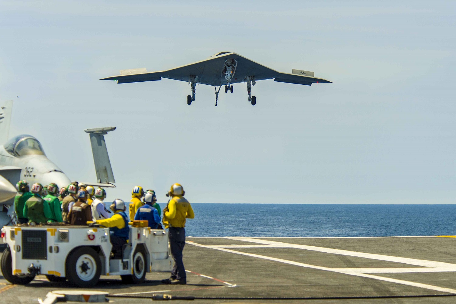ATLANTIC OCEAN (Aug. 17, 2014) The Navy's unmanned X-47B lands aboard the aircraft carrier USS Theodore Roosevelt (CVN 71). The aircraft completed a series of tests demonstrating its ability to operate safely and seamlessly with manned aircraft. U.S. Navy photo by Liz Wolter). 