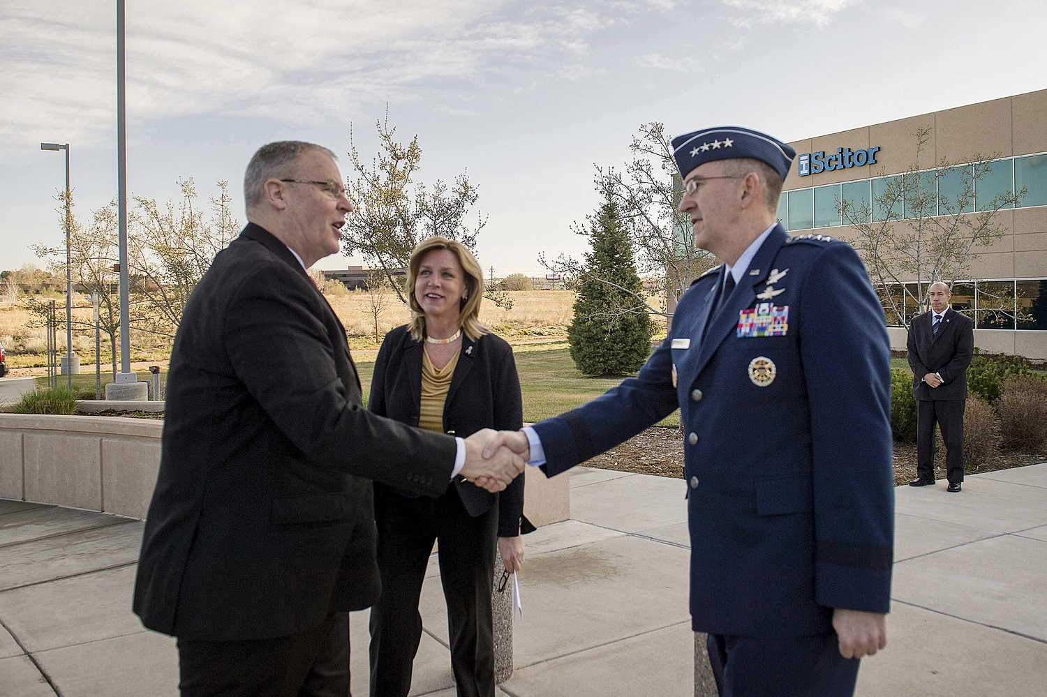 Air Force Gen. John E. Hyten, commander of Air Force Space Command, right, and Secretary of the Air Force Deborah Lee James, center, greet Deputy Defense Secretary Bob Work as he arrives at the Scitor Complex to attend and speak at the Space Symposium in Colorado Springs, Colo., April 15, 2015. DoD photo by U.S. Air Force Master Sgt. Adrian Cadiz  