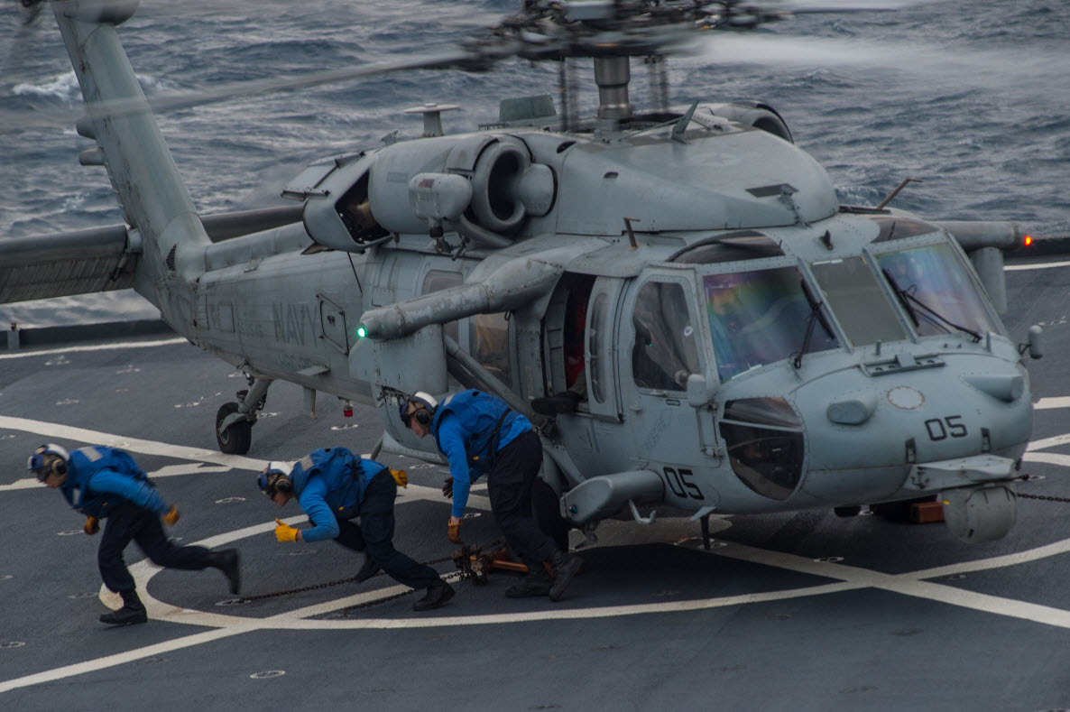 
EAST CHINA SEA (March 9, 2015)

 Hide Caption 


Sailors assigned to the Whidbey Island-class amphibious dock landing ship USS Ashland (LSD 48) take cover after chocking and chaining an MH-60S Sea Hawk helicopter assigned to the Island Knights of Helicopter Sea Combat Squadron (HSC) 25. Ashland is underway in the U.S. 7th Fleet area of responsibility. U.S. Navy photo by Mass Communication Specialist 3rd Class Christian Senyk 
