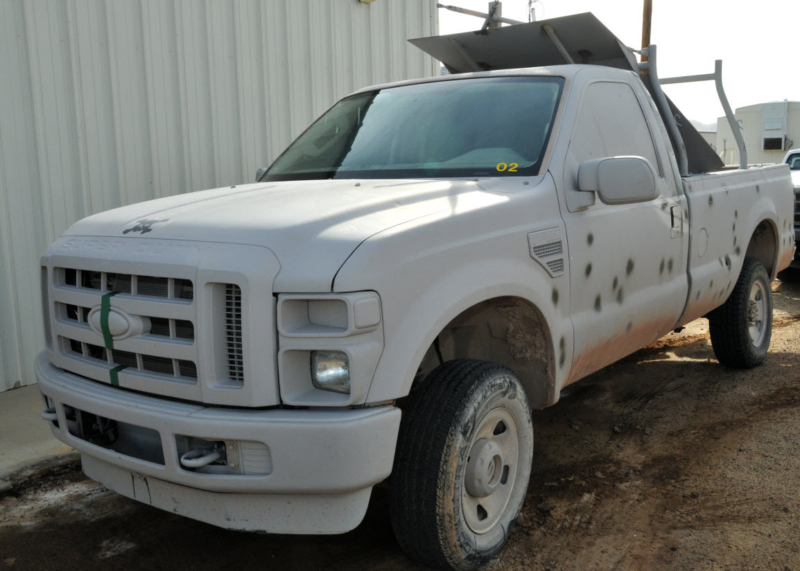 This truck is a semi-autonomous vehicle created and used by Naval Air Warfare Center Weapons Division as the Shoot-able Remote Threat Ground Target (SRTGT). The truck is designed to tow a trailer during weapons testing. The test weapon platform is fired at the trailer to preserve the truck’s system for future tests. It is painted with a non-reflective coating and is fitted with a blast shield in the bed that protects the cab and SRTGT system during a live-fire test. U.S. Navy photo.

