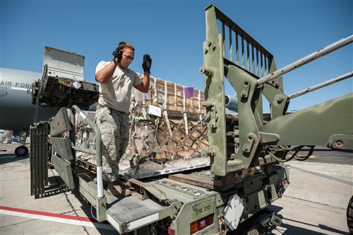 U.S. Air Force Tech. Sgt. Brian Leach, an aerial porter from the Kentucky Air National Guard’s 123rd Contingency Response Group, directs the positioning of a forklift to offload pallets of humanitarian aid from a Halverson cargo-handling vehicle at Léopold Sédar Senghor International Airport in Dakar, Senegal, Nov. 12, 2014. The cargo will be staged in Senegal before being transloaded to U.S. Air Force C-130J aircraft for delivery into Monrovia, Liberia, in support of Operation United Assistance, the U.S. Agency for International Development-led, whole-of-government effort to contain the Ebola virus outbreak in West Africa. (U.S. Air National Guard photo by Maj. Dale Greer)