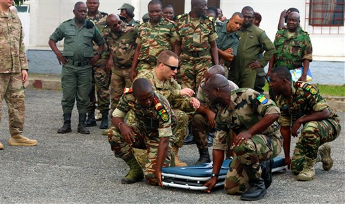 Maj. Jeffrey Sills, air medical evacuation pilot, 3rd Battalion, 126th Aviation Regiment, Massachusetts National Guard, gives instruction on a proper four-man litter carry on the Gabon Air Force Base during Central Accord 2016. U.S. Army Africa's exercise Central Accord 2016 is an annual, combined, joint military exercise that brings together partner nations to practice and demonstrate proficiency in conducting peacekeeping operations. (U.S. Army Africa photo by Spc. L'Erin Wynn/Released)