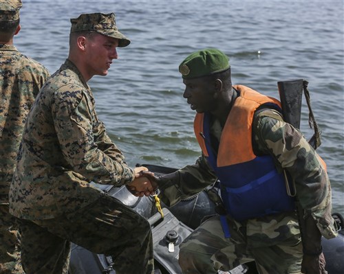 U.S. Marine Lance Cpl. Austin Carpenter, a rifleman, shakes his counterpart Compagnie Fusilier de Marin Commando’s hand after successfully completing the final exercise with U.S. service members in Dakar, Senegal, Sept. 17, 2015. The Marines and Coast Guardsmen with Special-Purpose Marine Air-Ground Task Force Crisis Response-Africa spent four weeks training the COFUMACO on basic infantry tactics and small-boat operations as a part of a Maritime Security Force Assistance mission to increase interoperability with Senegal’s and strengthen the bond between the partner nations. (U.S. Marine Corps photo by Cpl. Olivia McDonald/Released)