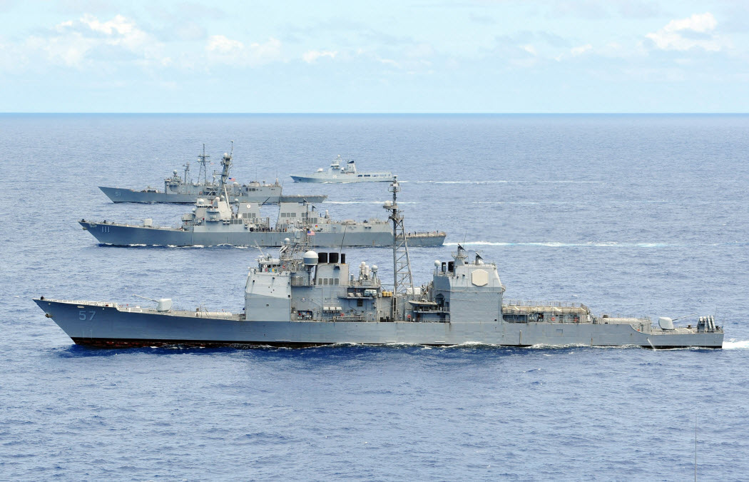 PACIFIC OCEAN (July 25, 2014) The Ticonderoga-class guided-missile cruiser USS Lake Champlain (CG 57), front, the guided-missile destroyer USS Spruance (DDG 111), the guided-missile cruiser USS Chosin (CG 65) and an unidentified partner ship are underway in a close formation during Rim of the Pacific (RIMPAC) 2014. Twenty-two nations, 49 ships, six submarines, more than 200 aircraft and 20,000 personnel are participating in RIMPAC Exercise from June 26 to Aug.1, in and around the Hawaiian Islands. The world's largest international maritime exercise, RIMPAC provides a unique training opportunity that helps participants foster and sustain the cooperative relationships that are critical to ensuring the safety of the sea lanes and security on the world's oceans. RIMPAC 2014 is the 24th exercise in the series that began in 1971. U.S. Navy photo by Mass Communication Specialist 1st Class Dustin Kelling.