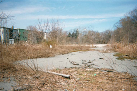 Contaminated former industrial land located next to a residential neighborhood in Lawrence.