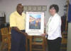 This year�s winning artist Kathy Sturch, Choctaw Nation of Oklahoma, and Arkansas Assistant State Conservationist Anderson Neal, look over the poster one last time before sending it to production.