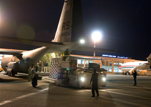 DJERBA, Tunisia -- U.S. airmen from the 435th Air Mobility Squadron out of Ramstein Air Base unload blankets, tarps and water containers donated by the U.S. Agency for International Development off of a C-130 aircraft in Djerba, Tunisia, March 4, 2011. The U.S. government is working intensely with the international community to meet the humanitarian needs of the Libyan people and others in the country who fled across the borders. (Air Force photo by Staff Sergeant Brendan Stephens)