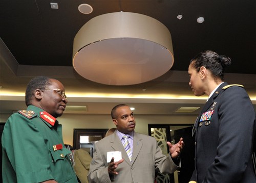 ARUSHA, Tanzania - General Greyson Indinga of the Tanzania People's Defence Forces (TPDF), left, talks with Erik Threet, U.S. Africa Command's Pandemic Response Program director, center, and Brigadier General Nadja West, commander of Europe Regional Medical Command, prior to the start of a week-long Tanzania National Pandemic Disaster Response Tabletop Exercise at Mount Meru Hotel in Arusha, Tanzania, March 7, 2011. (Photo by Khalfan Said for the U.S. Embassy, Tanzania) 