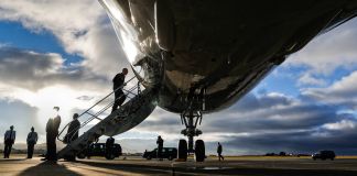 President Obama climbing aircraft stairs (© AP Images)