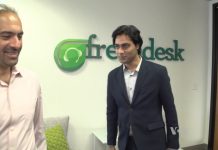 Two people in front of freshdesk logo (VOA)