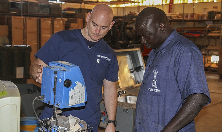 U.S. Army Reserve Chief Warrant Officer 3 David Bostic, biomedical technician, and Senegalese biomedical technician Sgt. Delhie Olbnye, work together to repair a blood pressure monitor during Medical Readiness Training Exercise 17-1 at La Sante des Armees Hospital in Dakar, Senegal. (U.S. Army photo by Maj. Simon Flake)