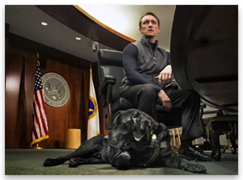 Tyler Kirk, WRP candidate, now an attorney with the Securities and Exchange Commission, at the agency's offices with his seeing eye dog, Sailor, a black Lab.