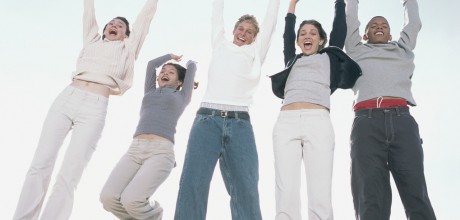 Photo of teens jumping in the air.