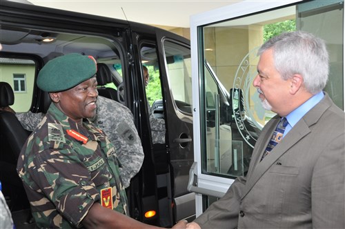 Ambassador Phillip Carter, III, deputy to the commander for civil-military engagement, greets Maj. Gen. Salim Mustafa Kijuu, land force commander of the Tanzanian People's Defence Force, during of a command sponsored visit coordinated by U.S. Army Africa July 8, 2015. 